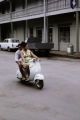 French Polynesia, people riding scooter in Papeete