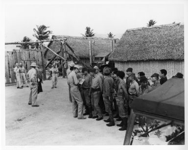 United States Marine Corps Reserves interpreters interrogating prisoners of war