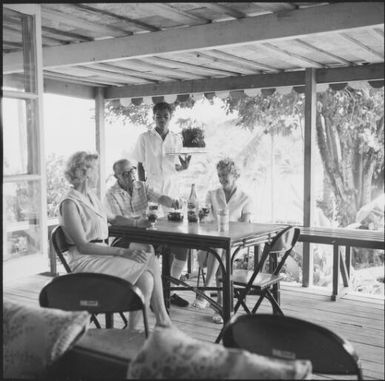 People having drinks on a covered deck, Savusavu, Fiji, 1966, 2 / Michael Terry