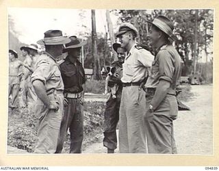 JACQUINOT BAY, NEW BRITAIN, 1945-08-08. OFFICERS CONFERRING ON THE MOVEMENT OF 41 LANDING CRAFT COMPANY TO BORNEO. IDENTIFIED PERSONNEL ARE:- CAPTAIN P.F. BOLAND (1); CAPTAIN G.D. AHON (2); ..