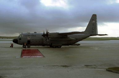 A US Air Force (USAF) C-130 Hercules from Yokota Air Base (AB), Japan, waits for passengers who will take part in the first flight of the 50th anniversary Christmas Drop flights at Andersen Air Force Base (AFB), Guam