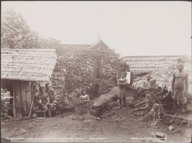 Local people standing near the fort in the village of Qarea, Malaita, Solomon Islands, 1906 / J.W. Beattie