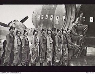 PROBABLY SYDNEY, NSW, 1944-08. WOMEN MEMBERS OF RAAF NO. 1 MEDICAL AIR EVACUATION UNIT IN UNIFORM, LINED UP WITH FLIGHT LIEUTENANT ALAN RANDALL OF NO. 37 SQUADRON, TO ENTER AN AIRCRAFT, POSSIBLY ON ..