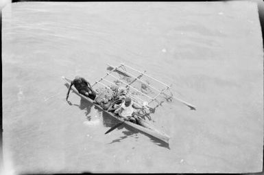 Looking down on two women in a laden outrigger canoe, Rabaul, New Guinea, ca. 1929, 2 / Sarah Chinnery