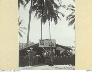 MILILAT, NEW GUINEA. 1944. THE RECREATION HUT JOINTLY RUN BY THE SALVATION ARMY AND THE AUSTRALIAN COMFORTS FUND SET AMONG THE COCONUT PALMS AT HEADQUARTERS, 5TH DIVISION