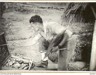 PORT MORESBY, PAPUA, NEW GUINEA. 1943-01-18. SX13471 SERGEANT G. R. MAINWARING, OFFICIAL WAR ARTIST, AUSTRALIAN MILITARY HISTORY SECTION, ATTACHED TO HEADQUARTERS, NEW GUINEA FORCE, EXECUTING A ..