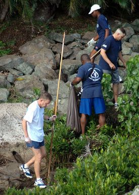 Led by US Navy (USN) Captain (CAPT) Dell Epperson (left) and Commodore, Afloat Training Group (ATG), Middle Pacific (ATG MIDPAC), Sailors assigned to ATG MIDPAC clean up trash and debris from the shorelines of historic Ford Island, Pearl Harbor, Hawaii (HI). Ford Island is adjacent to Battleship Row, home of the USN Iowa Class Battleship Missouri (BB 63) and USS Arizona Memorial