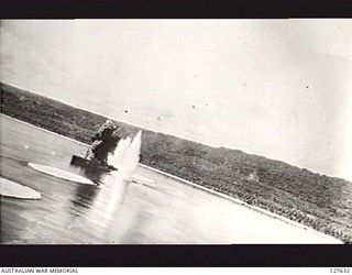 WEWAK, NEW GUINEA. 1944. ATTACK BY B25 BOMBER AIRCRAFT OF FIFTH AIR FORCE, UNITED STATES ARMY AIR FORCE ON JAPANESE SHIPPING IN THE HARBOUR. A STRING OF BOMBS HAS JUST MADE A DIRECT HIT