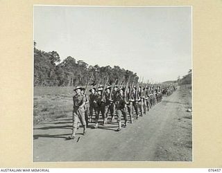 LAE, NEW GUINEA. 1944-10-07. A MARCH PAS OF THE 2/8TH COMMANDO SQUADRON. IDENTIFIED PERSONNEL ARE: QX765 LIEUTENANT R.G. BUCKRIDGE (1) CORPORAL W. TAPSFIELD (2); CORPORAL W. FLETCHER (3); CORPORAL ..