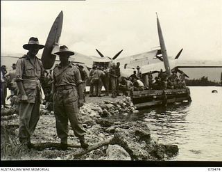 Jacquinot Bay, New Britain. 1945-03-10. NX442 Colonel J.A. McComb, Director of Docks, Land Headquarters, on the left, with VX14904 Captain F. Boland, 33rd Australian Port Operating Company, at the ..