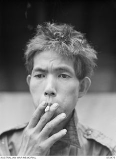 DUMPU, NEW GUINEA. 1944-04-19. ONE OF FOUR JAPANESE PRISONERS OF WAR AWAITING INTERROGATION BY INTELLIGENCE OFFICERS AT HEADQUARTERS 11TH DIVISION. THE PRISONERS, CAPTURED AT NAP NAP ON THE WANTOAT ..