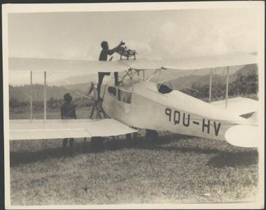 Refuelling VH-UQP De Havilland plane by kerosene tin, Salamaua, New Guinea, 1933 [1] Sarah Chinnery