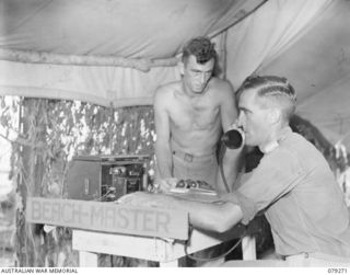 KEIP, NEW BRITAIN. 1945-02-18. QX50510 LIEUTENANT L.G. PERRY, BEACHMASTER, 19TH INFANTRY BATTALION (1) BUSILY ENGAGED IN DIRECTING THE CRAFT IN THE AREA. IDENTIFIED PERSONNEL IS:- N464052 PRIVATE ..