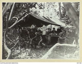 KARAWOP AREA, NEW GUINEA. 1945-04-20. MEMBERS OF 2/1 INFANTRY BATTALION WAITING FOR TREATMENT FROM 2/3 DENTAL UNIT. THIS IS THE FIRST TIME IN ANY CAMPAIGN THAT A DENTAL UNIT WAS UP WITH A FORWARD ..