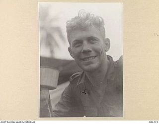 25661 Warrant Officer (later Flight Sergeant [Flt Sgt]) John William Hamilton, No. 8 Squadron RAAF, drinks a mug of tea following his return from a patrol with members of a company, 2/4 Infantry ..
