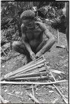 Pig festival, wig ritual, Tsembaga: man builds frame for elevated oven in which food for wig men will be cooked