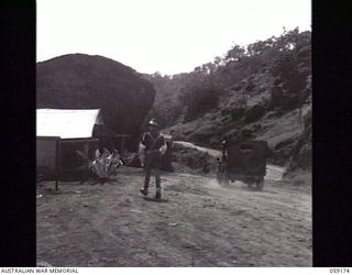 SOGERI VALLEY, NEW GUINEA. 1943-11-05. LOOKING FROM THE ROUNA TRAFFIC CONTROL POINT NO. 2 TOWARDS THE VALLEY WHERE THE ROAD BECOMES TWO WAY TRAFFIC AGAIN. PROVOST ON DUTY IS NX154422 CORPORAL D. B. ..