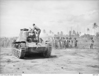 RAPOPO AIRSTRIP, NEW BRITAIN. 1945-09-28. A JAPANESE TANK CREW BRINGING A TYPE 97 CHI-HA MEDIUM TANK OUT OF THE LINES TO HAND OVER TO AUSTRALIAN CREWS OF 2/4 ARMOURED REGIMENT. A TOTAL OF OVER 40 ..