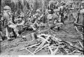 TOROKINA AREA, BOUGAINVILLE ISLAND. 1944-11-29. TROOPS OF NO.18 PLATOON, D COMPANY, 9TH INFANTRY BATTALION WAITING UNDER COVER OF GEORGE HILL 15 MINUTES BEFORE THE OPENING OF THE ATTACK ON LITTLE ..