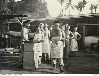 PORT MORESBY, PAPUA. C. 1942-12. PILOT OFFICER A. JORDON COMES FROM CANBERRA, ACT, BUT HE IS SANTA CLAUS TO ONE RAAF SQUADRON IN THE JUNGLE. THE SQUADRON COOKS ARE RECEIVING AUSTRALIAN COMFORTS ..