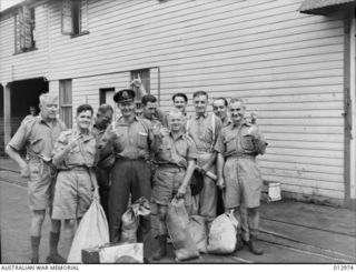 A GROUP OF THE SURVIVORS OFF THE "MACDHUI" SUNK IN PORT MORESBY ON 18 JUNE 1942. THE SEAMEN WERE ABLE TO SAVE ONLY THE CLOTHES THEY WERE WEARING BUT NEVERTHELESS THEY COULD RAISE A SMILE. MOST OF ..