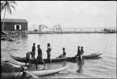 Mon canoe on beach, long jetty in background, New Guinea, ca. 1929 / Sarah Chinnery