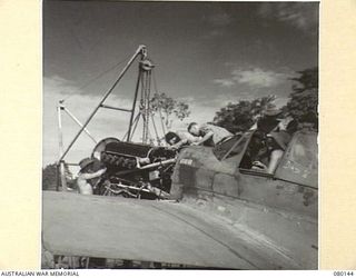 NADZAB, NEW GUINEA. 1944-06-26. A P-40 CURTISS KITTYHAWK AIRCRAFT AT NO. 4 TACTICAL RECONNAISSANCE SQUADRON, ROYAL AUSTRALIAN AIR FORCE, UNDER MINOR INSPECTION. THESE OVERHAULS ARE CARRIED OUT AT ..
