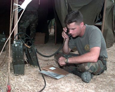 US Marine Corps Captain Sojourner, 1ST Marine Expeditionary Force Tactical Exercise Contingencey Group, makes radio contact with other rebel force roll players prior to an amphibious assault landing during RIMPAC '96 at Pacific Missile Range Facility, Barking Sands, Kauai, Hawaii