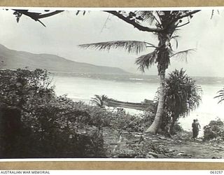 WANDOKAI, NEW GUINEA. 1944-01-01. LOOKING ALONG THE COAST TOWARDS BLUCHER POINT FROM WANDOKAI, SHOWING A WRECKED JAPANESE BARGE IN THE MIDDLE DISTANCE