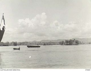 ALEXISHAFEN, NEW GUINEA. 1944-09-18. NAVAL CRAFT IN A SECTION OF THE HARBOUR, WITH THE STERN OF A UNITED STATES NAVY VESSEL AT THE EXTREME LEFT