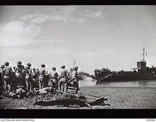 MILNE BAY, NEW GUINEA. 1943-07-12. 29TH AUSTRALIAN INFANTRY BRIGADE, 5TH AUSTRALIAN DIVISION, EMBARK ON NEW AMERICAN LANDING CRAFT (27) FOR BUNA, AT GILI GILI. SHOWN: QX40783 CAPTAIN E. D. ..