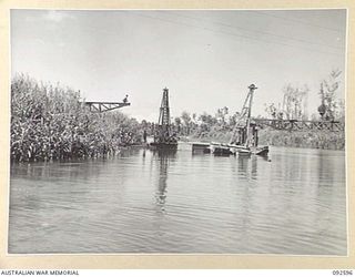 SOUTH BOUGAINVILLE, 1945-05-27. THE SAVIGE BRIDGE OVER THE JABA NO. 1 RIVER ALMOST COMPLETED. CONSTRUCTED BY MEMBERS OF 11 FIELD COMPANY ROYAL AUSTRALIAN ENGINEERS, IT WAS COMPLETED IN FIVE WEEKS ..