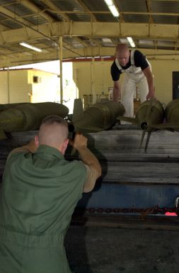 US Air Force (USAF) Airmen assigned to the 7th Expeditionary Munitions Squadron load Mark 82 500-pound general purpose bombs on a munitions trailer at Andersen Air Force Base, Guam, during Operation IRAQI FREEDOM