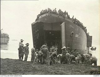 AITAPE AREA, NORTH EAST NEW GUINEA. C. 1944-04-22. RAAF PERSONNEL OF MOBILE WORKS, SURVEY AND SIGNALS UNITS PREPARE A TRACK TO ENABLE HEAVY EQUIPMENT TO BE BROUGHT ASHORE FROM A LANDING SHIP, TANK ..