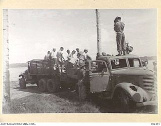 KAIRIRU ISLAND, NEW GUINEA, 1945-09-11. JAPANESE NAVAL MARINES TRANSFERRING THEIR EQUIPMENT AND BELONGINGS FROM THEIR TRUCK TO AN AUSTRALIAN TRUCK FOR TRANSFER TO MUSCHU ISLAND. AS THE ADVANCE ..