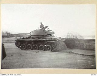 TOROKINA AREA, BOUGAINVILLE, 1945-08-06. AN M24 GENERAL CHAFFEE LIGHT TANK MAKING A LEFT HAND TURN ON SAND AT HIGH SPEED DURING TRIALS CONDUCTED FOR THE WAR OFFICE