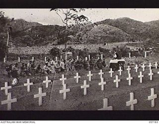 WAU, NEW GUINEA. 1943-08-29. VX117249 CHAPLAIN W. A. O'DRISCOLL, ROMAN CATHOLIC, OFFERING THE FIRST REQUIEM MASS FOR ALLIED TROOPS, IN THE WAU WAR CEMETERY