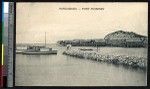 Men standing on a stone jetty with a view of the bay, Port Moresby, Papua New Guinea, ca.1900-1930