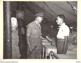 TOROKINA, BOUGAINVILLE, 1945-07-03. HIS ROYAL HIGHNESS, THE DUKE OF GLOUCESTER, GOVERNOR-GENERAL OF AUSTRALIA (1), SPEAKING WITH PRIVATE R.P.A. LOOKER, 58/59 INFANTRY BATTALION (2), A PATIENT AT ..