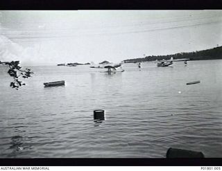 Jacquinot Bay, New Britain. c.1945. Jacquinot Bay Catalina Base showing two A24 Consolidated Catalina aircraft and a captured Japanese Aichi E13A1 (Jake) Navy single engined twin float ..