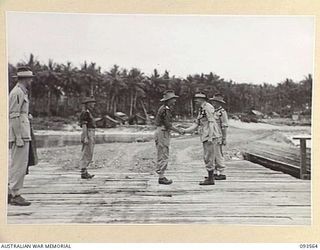 TOL PLANTATION, WIDE BAY, NEW BRITAIN. 1945-07-02. HIS ROYAL HIGHNESS, THE DUKE OF GLOUCESTER, GOVERNOR-GENERAL OF AUSTRALIA (4), VISITED HEADQUARTERS 13TH INFANTRY BRIGADE. HE IS BEING GREETED ON ..