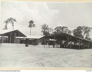 TOROKINA, BOUGAINVILLE ISLAND. 1944-12-04. THE TRANSIT SHED (RIGHT) AND "A" SUB DEPOT (LEFT) AT HEADQUARTERS, 2ND BASE SUPPLY DEPOT