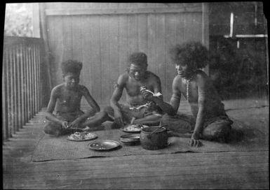 Three Papuans eating on a verandah, Papua, ca. 1923 / Sarah Chinnery