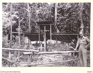 RAMALE MISSION, KOKOPO AREA, NEW BRITAIN, 1945-09-19. THE MISSION CEMETERY; NATIVES FROM THE NEARBY VILLAGE CARVED THE CRUCIFIX FIGURE