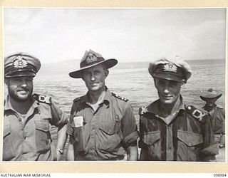 WEWAK HARBOUR, NEW GUINEA. 1945-11-25. LIEUTENANT G.K. DINSDALE (1), LIEUTENANT E.E.R. TRICKETT (2), AND LIEUTENANT J.W. MCGUIRE (3), NAVAL OFFICERS OF HMAS SHROPSHIRE, WHO SUPERVISED THE ..