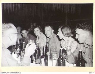 LAE, NEW GUINEA, 1945-12-01. PERSONNEL ATTENDING A FORMAL MESS IN THE SERGEANTS' MESS, 2/1 BASE WORKSHIP, ON THE OCCASION OF THE THIRD ANNIVERSARY OF THE FORMATION OF THE CORPS OF AUSTRALIAN ..