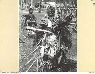 SONG RIVER, FINSCHHAFEN AREA, NEW GUINEA, 1944-03-26. A SIO NATIVE PICTURED DURING A SING-SING HELD IN THE AUSTRALIAN NEW GUINEA ADMINISTRATIVE UNIT COMPOUND TO CELEBRATE RE OCCUPATION OF THE AREA