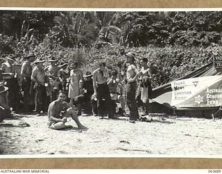 HUON PENINSULA, NEW GUINEA. 1944-01-14. YOUNG MEN'S CHRISTIAN ASSOCIATION STALL ON THE BEACH AT THE MOUTH OF THE SANGA RIVER CATERING FOR THE TROOPS OF THE 9TH AUSTRALIAN DIVISION