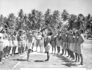 TARAWA ISLAND, GILBERT AND ELLICE ISLAND GROUP. 1945-09-27. THE CAPTAINS OF CRICKET TEAMS FROM HMAS DIAMANTINA AND GILBERT ISLAND TOSSING TO SEE WHICH SIDE WILL BAT. HMAS DIAMANTINA IS ON ITS WAY ..