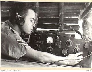 NEW GUINEA. 1942-08-28. SIGNALLERS' OUTPOST WITH CORPORAL DAVE WIGHTON OPERATING THE EQUIPMENT